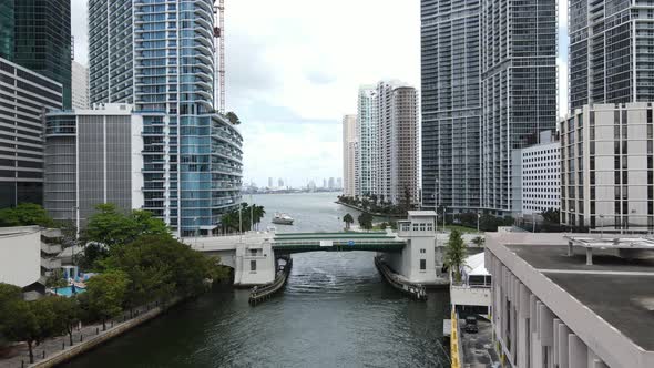 Aerial view of a mega yacht approaching the Miami River before the Brickell Avenue Bridge and beauti