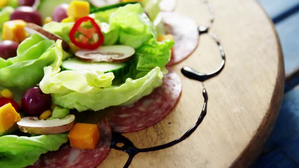 Salad decorated on wooden plate