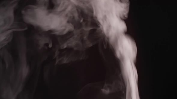 White smoke, fog, mist, vapor on a black background.