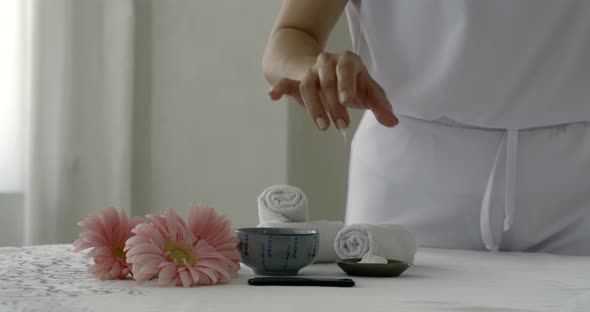 Massagist Is Taking Cream From Bowl in Spa Salon During Procedure