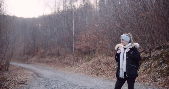 Smiling Female Tourist Walking Trail in Mountains