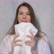 A Young Housewife Woman Takes a Stack of Fresh Washed Clean Linen in Her Hands - VideoHive Item for Sale