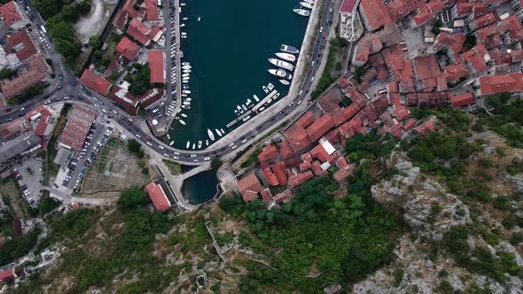 Cinematic birdseye aerial over the old town and the harbour in Kotor Montenegro a popular destinatio