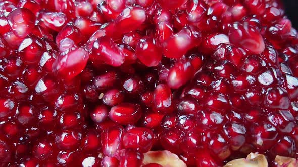 Juicy Red Pomegranate Grains Are Falling Down