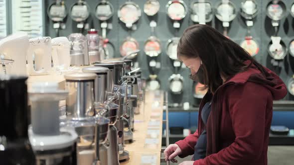 Pregnant Woman in Protective Mask Chooses a Blender in Shop