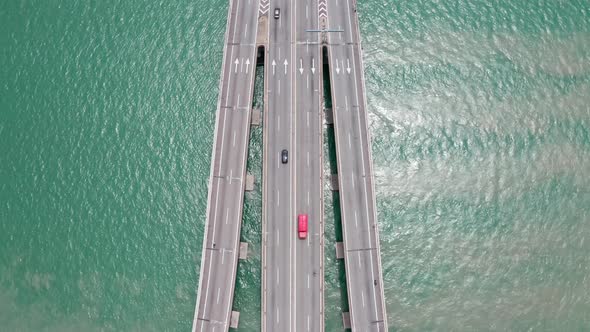 Aerial surface view of Penang Bridge Malaysia traffic lanes with bidirectional traffic, drone bird's
