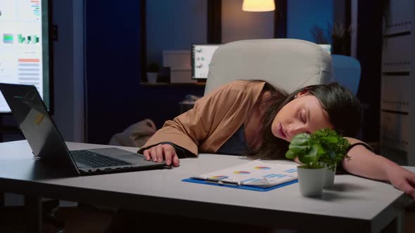 Exhausted Tired Businesswoman Sleeping on Desk Table in Startup Business Office