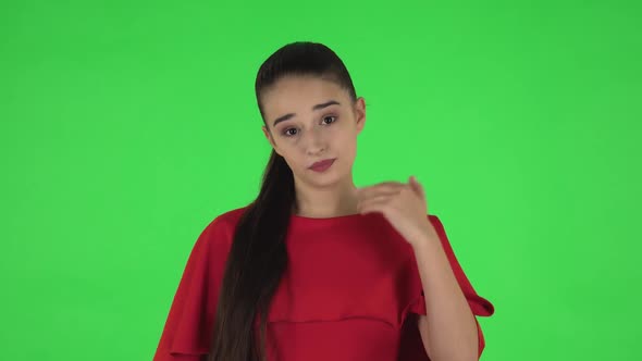 Portrait of Pretty Young Woman Is Waving Hand and Showing Gesture Come Here Then Upset. Green Screen