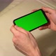 Holds Smartphone with Green Screen - VideoHive Item for Sale