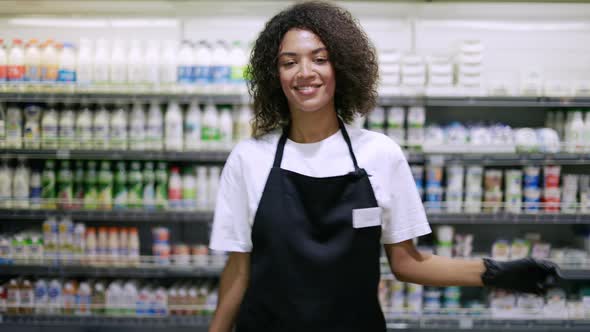Smiling Worker in Black Apron Dancing in Supermarket Having Fun During Work
