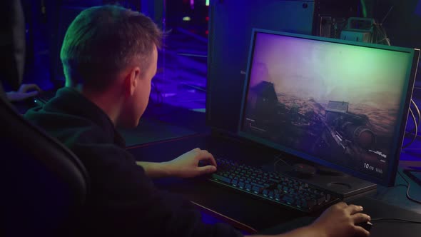 Young Male Gamer Enjoys Pc Video Game Activity Playing Military Combat Simulator alt