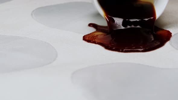 Pouring Out Coffee on White Cloth Closeup