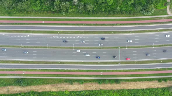 Aerial view over a highway interchange during peak hour traffic.