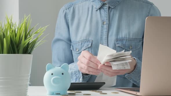 Woman Calculating Finance Money Using Calculator Laptop Computer at Home Workplace Table Counting