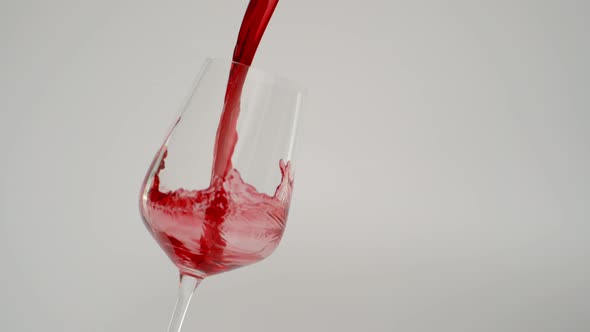 Pouring Red Wine in Tilted Glass at 1000 Fps White Background