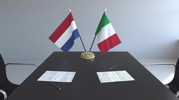 Flags of the Netherlands and Italy on the Table