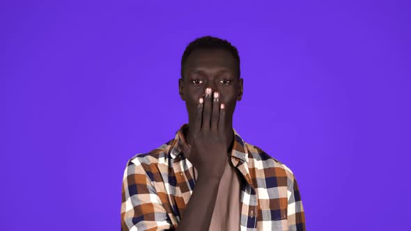 Afro American Man Over Isolated Over Blue Background Looking at the Camera Blowing a Kiss with Hand