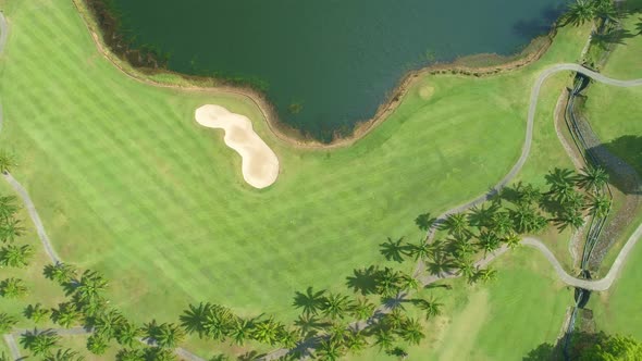 Aerial view of Golf Course with putting green grass and trees on golf field Fairway