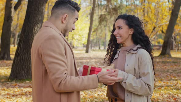 Guy Covers Eyes with Hands Girl Makes Unexpected Present to Man for Birthday Couple Hug Outdoors Man