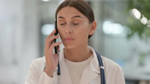 Portrait of Female Doctor Talking on Smartphone 