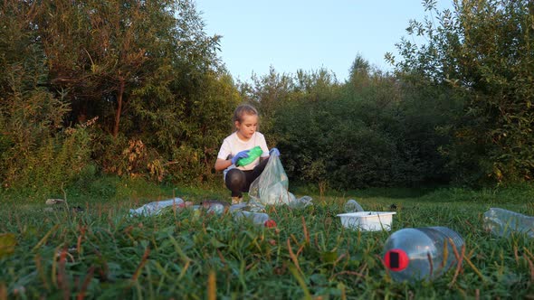 Girl in Gloves Picking Up Trash in the Forest