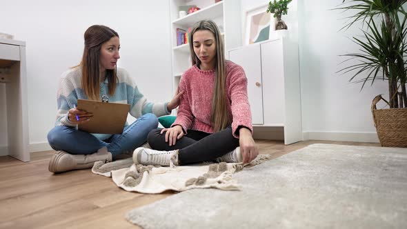 Sad Teenager Girl Having Conversation with Young Therapist Counselor Who Offers Help Advice and