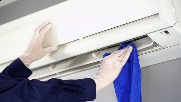 close up technician service cleaning the air conditioner with cloth