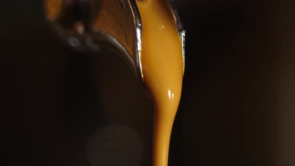 Closeup Of Pouring Coffee Stream From Professional Machine