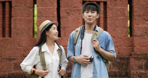 Couple videoblogger talking and looking at camera at ancient temple