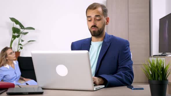 Businessman Works in the Living Room on the Computer