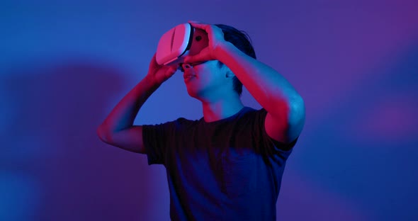 Man Looking Though the VR Device with Red and Blue Light