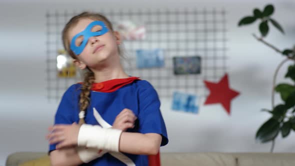 Little Girl in Superhero Costume Posing for Camera