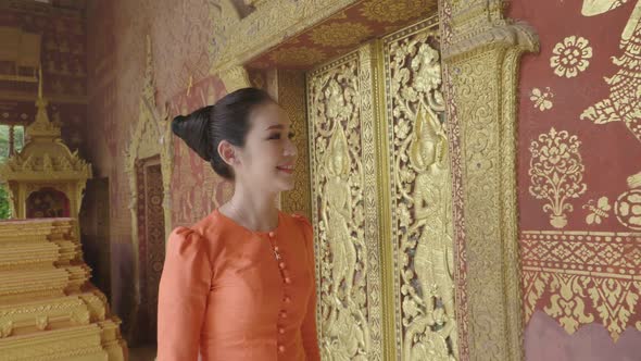 Asian Girl Wearing Traditional Dress Walking And Looking Temple Wall