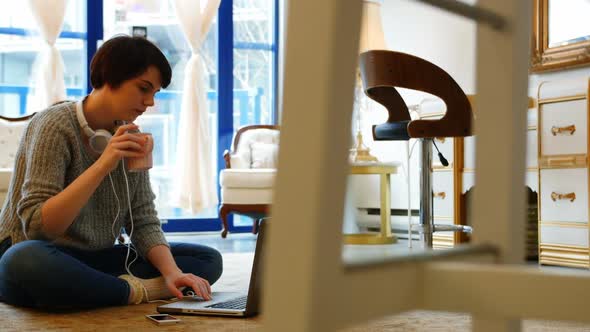 Woman using mobile phone in living room