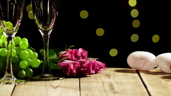 Still Life Confined to Valentine's Day with Two Wineglasses and Roses Lying Next to Grape
