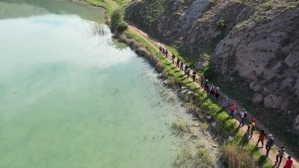 Group Of People Trekking By The Lake 2