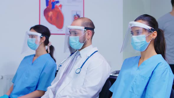 Group of Medical Personnel with Visor and Face Mask