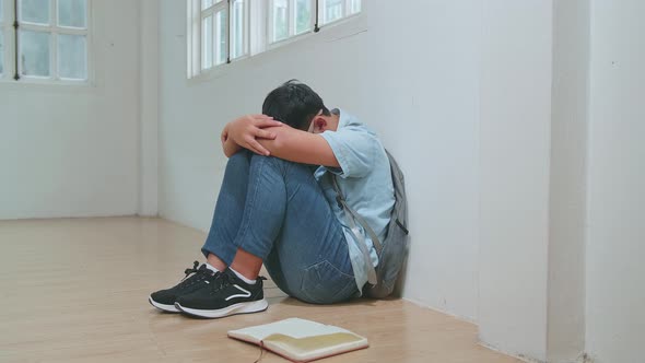 Asian Boy Sitting Alone With Sad Feeling At School. Bullying, Discrimination And Racism Concept