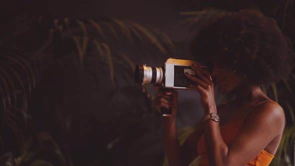 Woman With Afro Hair Filming With Vintage 8Mm Camera