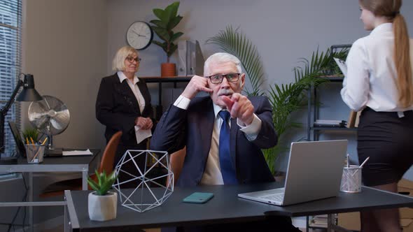 Portrait of Business Man in Office Looking Camera Doing Phone Gesture Like Says Hey you Call Me Back