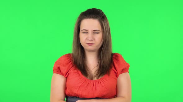 Portrait of Cute Girl Is Gesturing Expressing Irritation and Anger. Green Screen