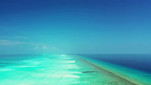 Daytime birds eye abstract shot of a white sandy paradise beach and aqua turquoise water background 