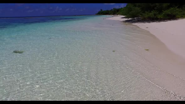 Aerial top down abstract of idyllic tourist beach holiday by blue sea with white sand background of 