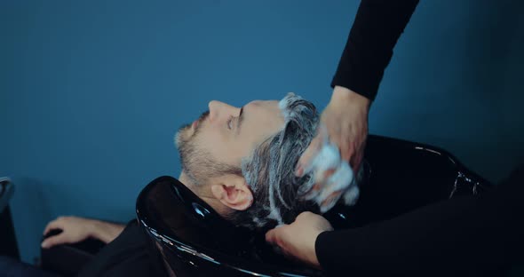 Hairdresser Washes the Client Before Cutting the Hair