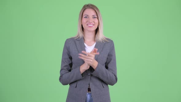 Happy Young Blonde Businesswoman Clapping Hands