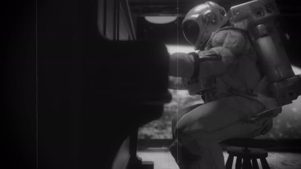 Astranaut in a Spacesuit Plays the Piano in a Spaceship Overlooking the Planet Earth