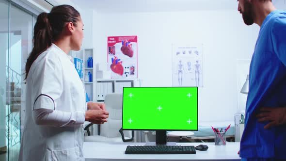 Doctor Analysing Patient Results with Assistant