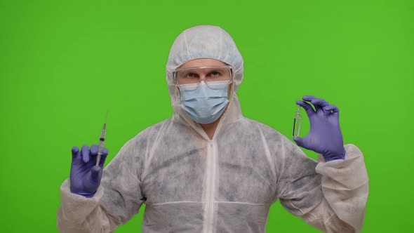 Doctor in PPE Suit with Vaccine Ampoule Syringe in Hands Offering Vaccination Against Coronavirus