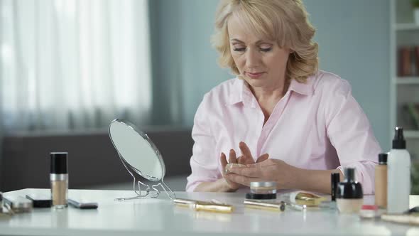 Senior Woman Using Lot of Expensive Makeup Hiding Age-Related Skin Changes