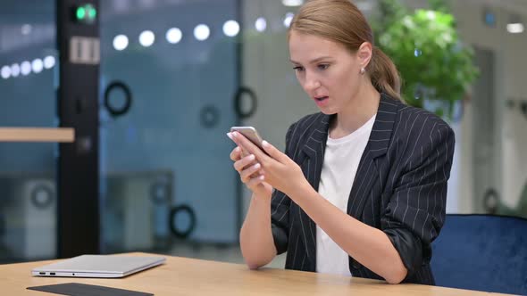 Disappointed Young Businesswoman Having Loss on Smartphone